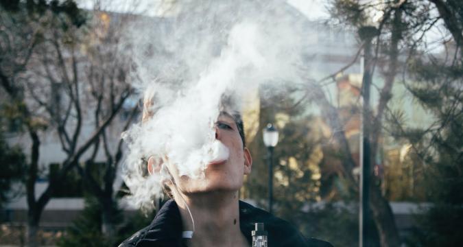 photography of a man using vape