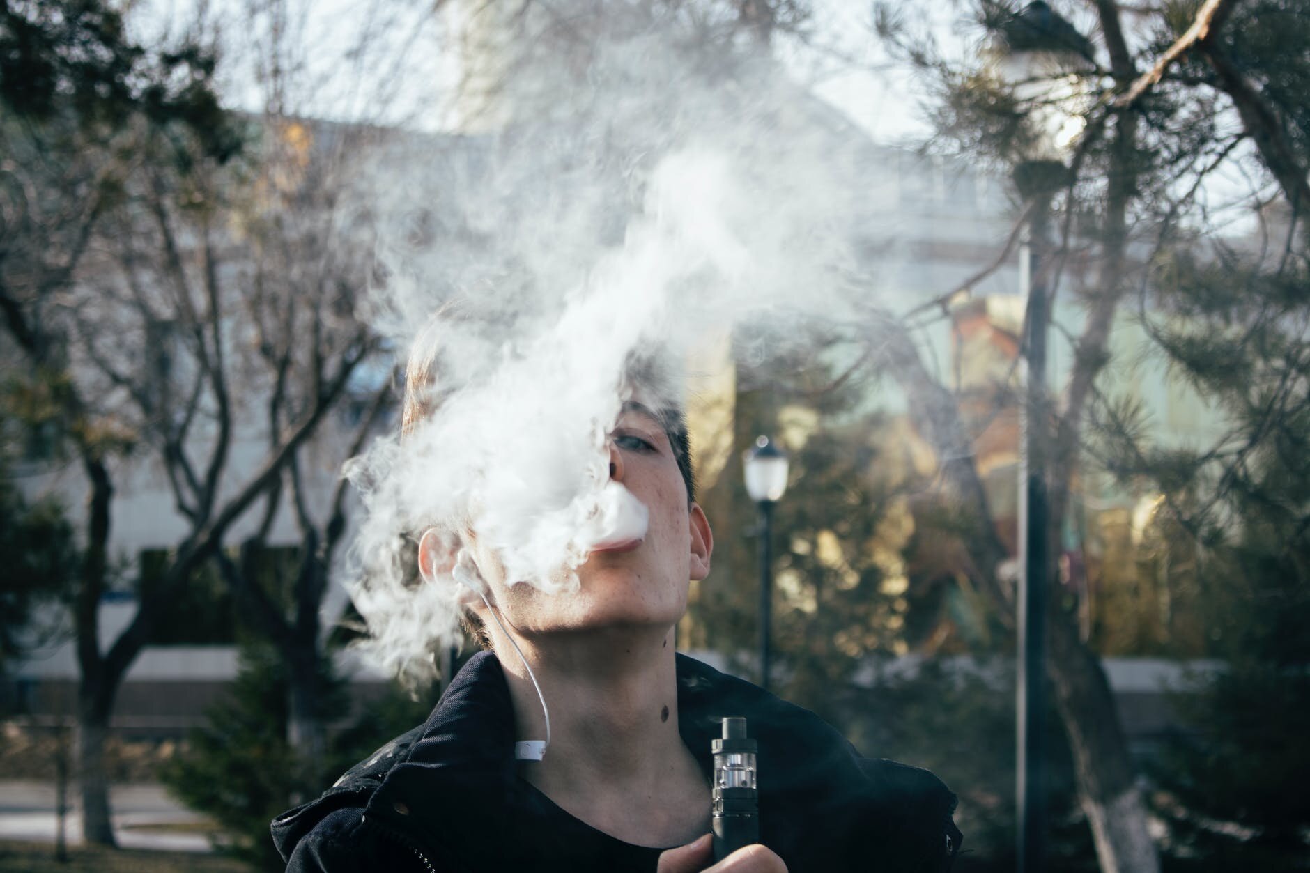 photography of a man using vape