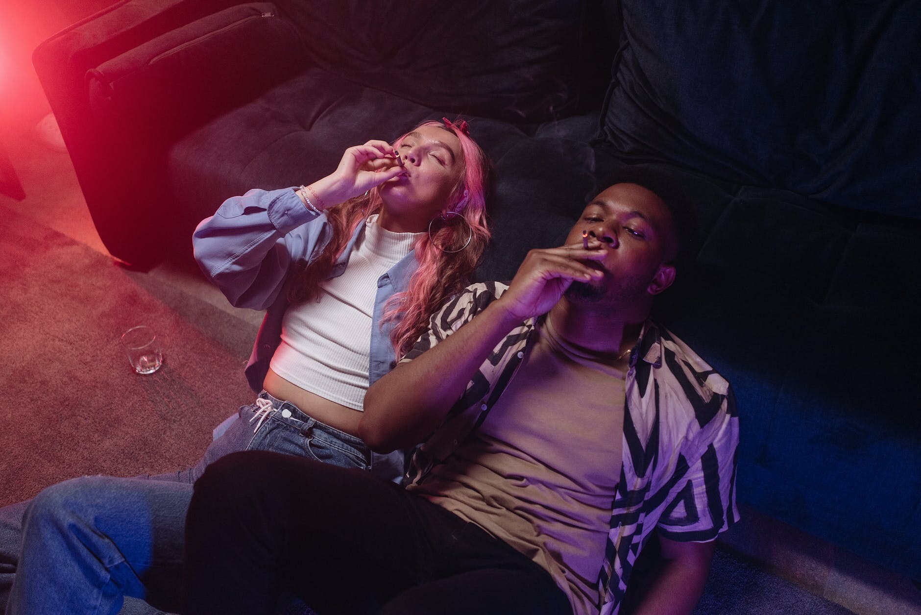 a man and a woman smoking together